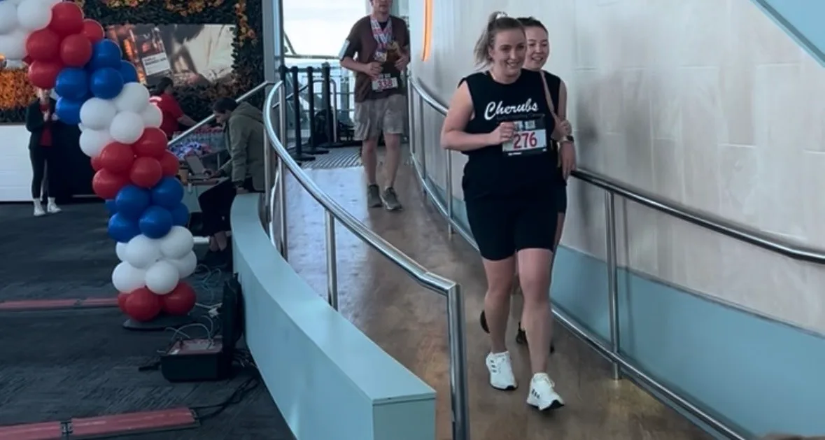 Two Cherubs team members in Cherubs singlets finishing the Q1 stair climb at the SkyPoint observation deck